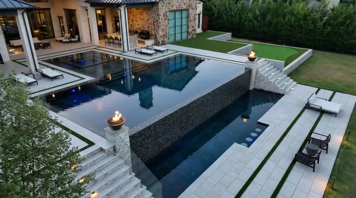 Completed luxury pool with fire bowls and infinity edge — built by Prestige Pool & Patio